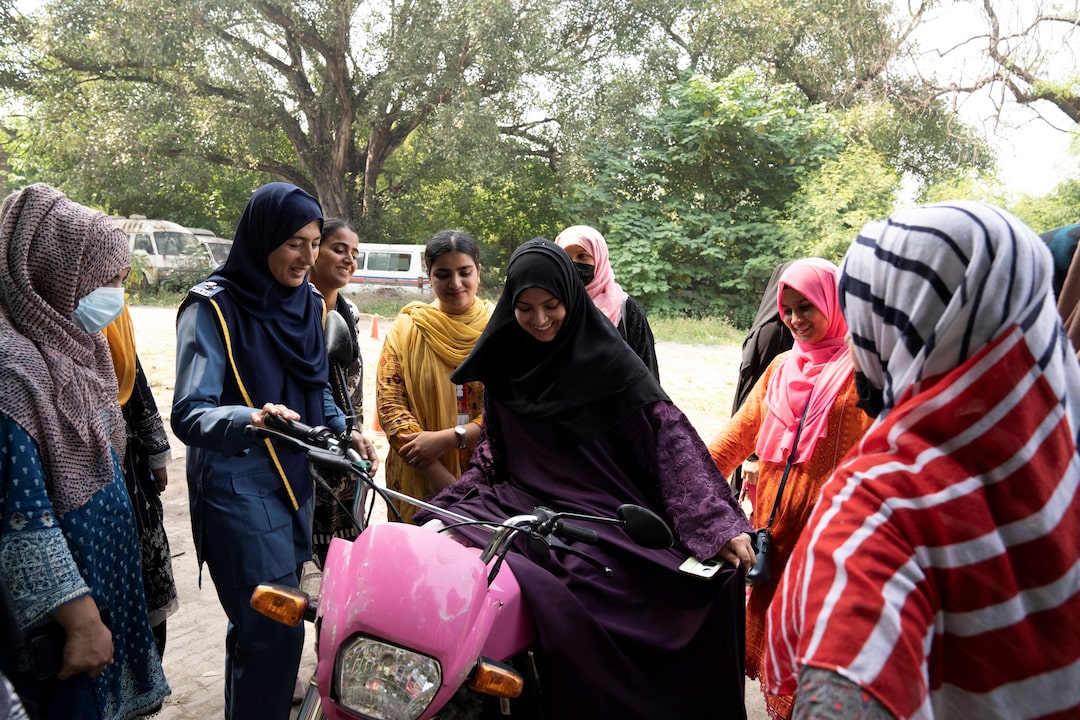 Humaira Rafaqat, a senior traffic warden, teaches women how to ride a bike while wearing an abaya, during a training session as part of the "Women on Wheels" program organised by the traffic police department in Lahore, Pakistan.
