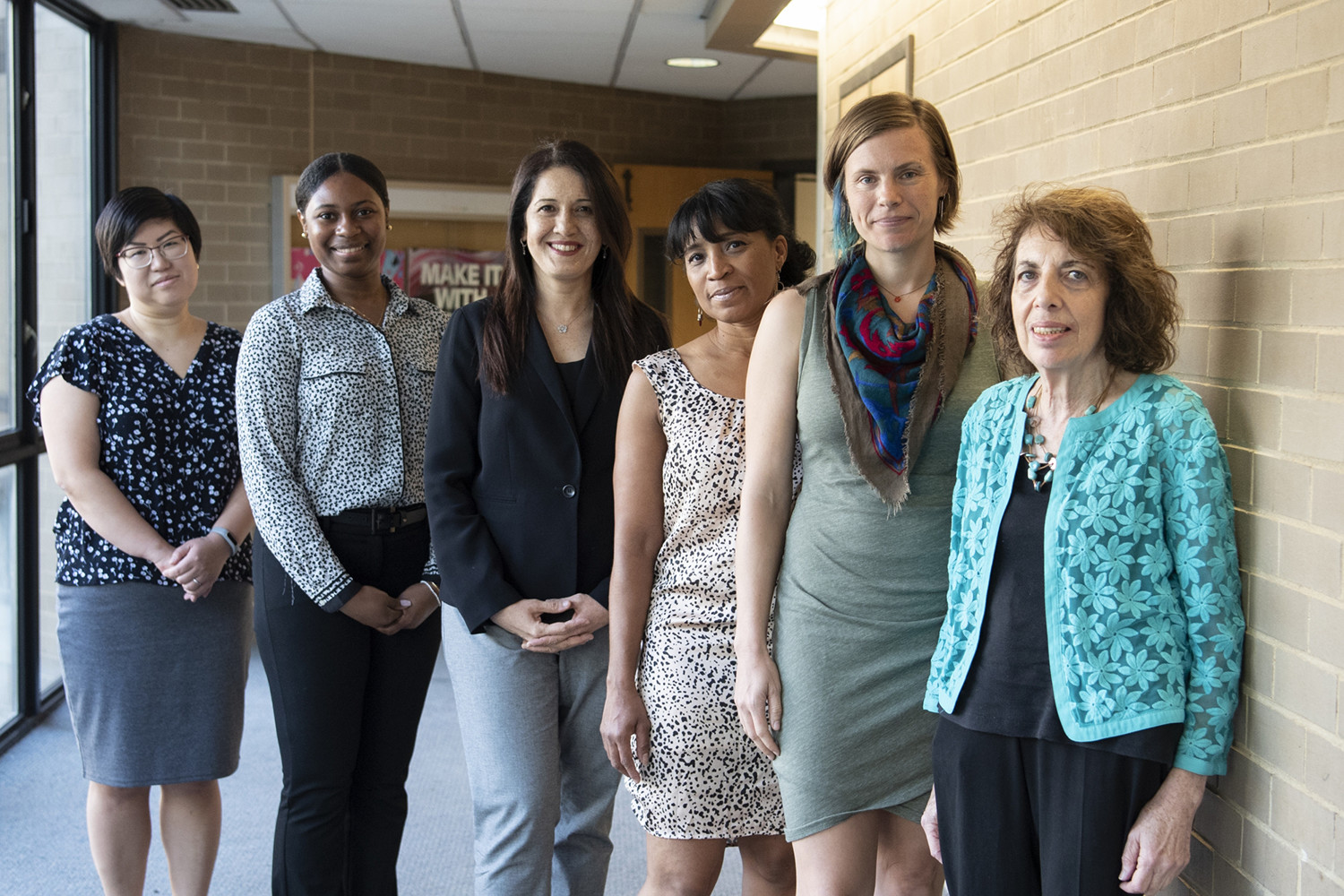 WGSS Faculty in a hallway corridor standing together to pose for a photo