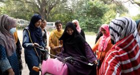Humaira Rafaqat, a senior traffic warden, teaches women how to ride a bike while wearing an abaya, during a training session as part of the "Women on Wheels" program organised by the traffic police department in Lahore, Pakistan.