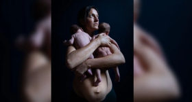 Mother holding two newborn babies
